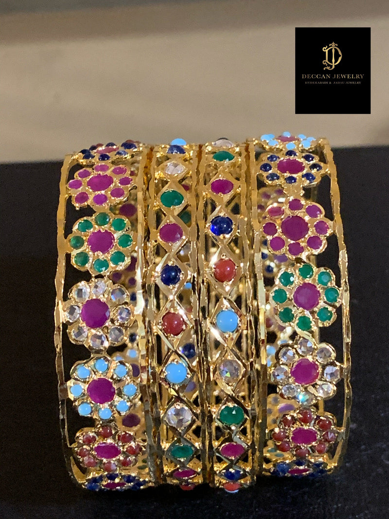 A side view of gold-plated Kundan work, complemented with vibrant colors and designs of the meenakari work. Highlighting the two different designs