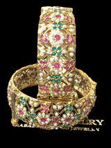 Bangle is shown in full display, highlighting intricate stone setting, gold plating, and design work. 