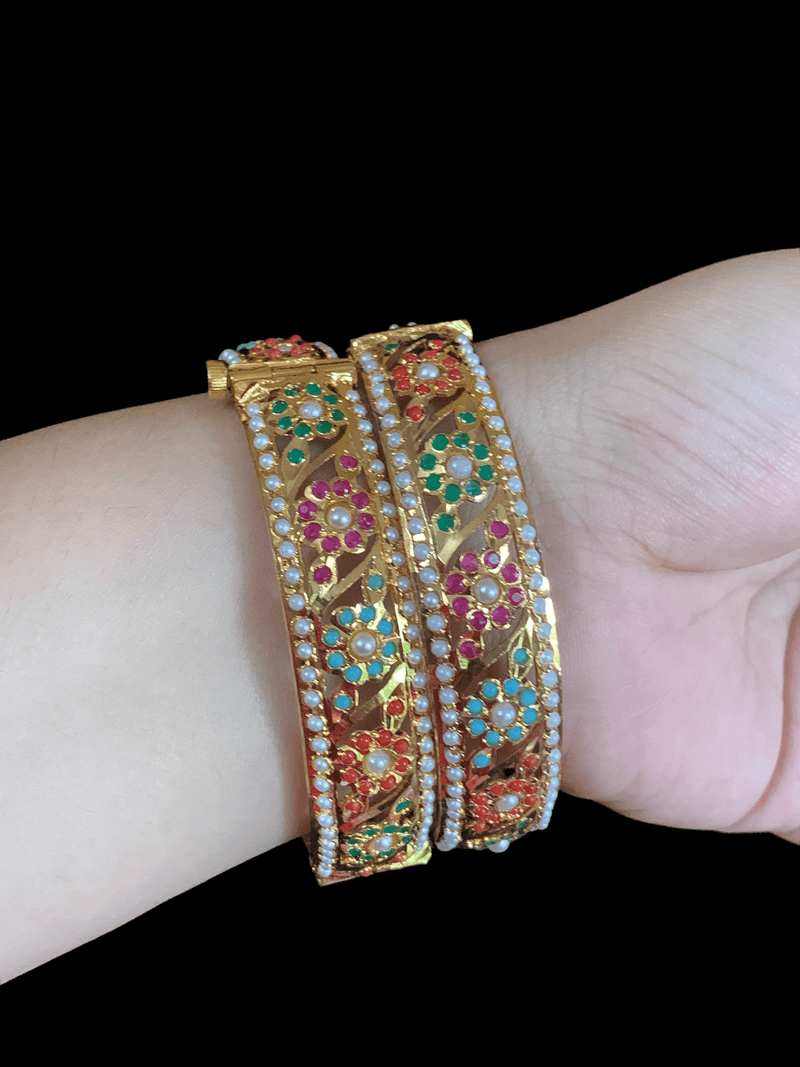 Pair of bracelets being worn to showcase the size and detail work of bracelets. 